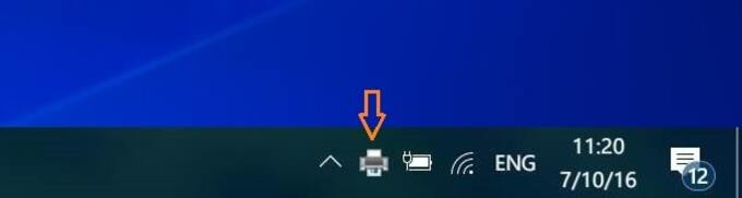 Nhấp đúp chuột vào biểu tượng máy in ở thanh Taskbar